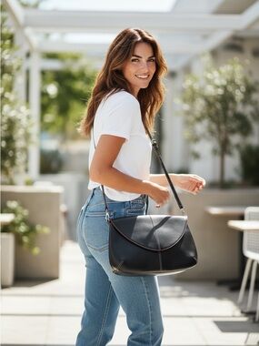 Lodi’s Audrey Collection leather crossbody bag with red piping detail